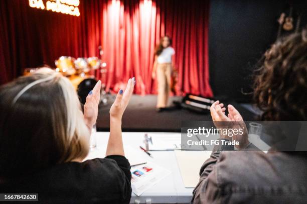 judges clapping to a contestant in a music contest - latino media awards show stock pictures, royalty-free photos & images