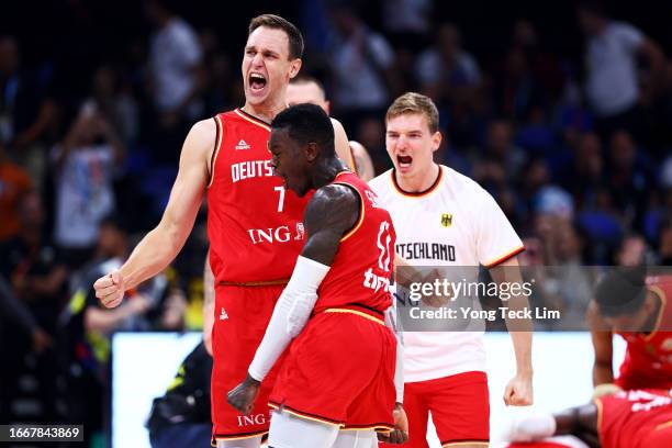 Johannes Voigtmann and Dennis Schroder of Germany celebrate after the FIBA Basketball World Cup semifinal game victory over the United States at Mall...