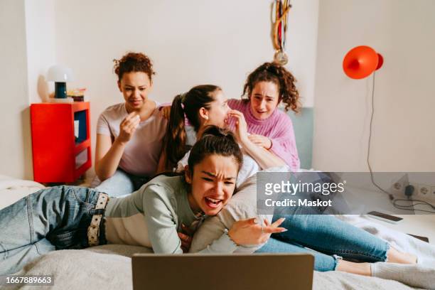 female friends watching movie together at home - pillow icon stock pictures, royalty-free photos & images