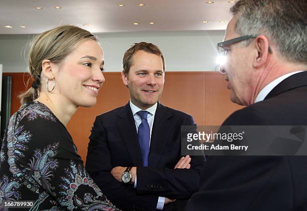 German Family Minister Kristina Schroeder, German Health Minister Daniel Bahr and German Defense Minister Thomas de Maiziere speak to one another as...