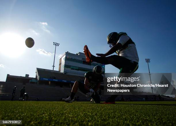 Cypress Falls players warm up as temperatures still exceed 100 degrees before a high school football game at Pridgeon Stadium, Thursday, Sept. 7 in...
