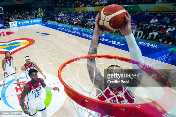 Daniel Theis of Germany dunks the ball past Jaren Jackson Jr. #13 of the United States in the first half during the FIBA Basketball World Cup...