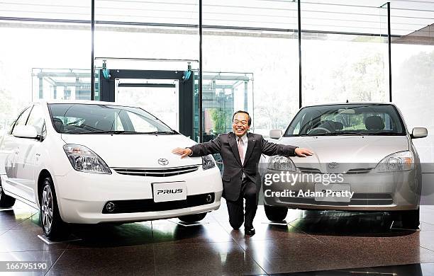 Vice Chairman of Toyota Takeshi Uchiyamada poses with Prius cars after speaking to the media on April 17, 2013 in Tokyo, Japan. Toyota announces the...