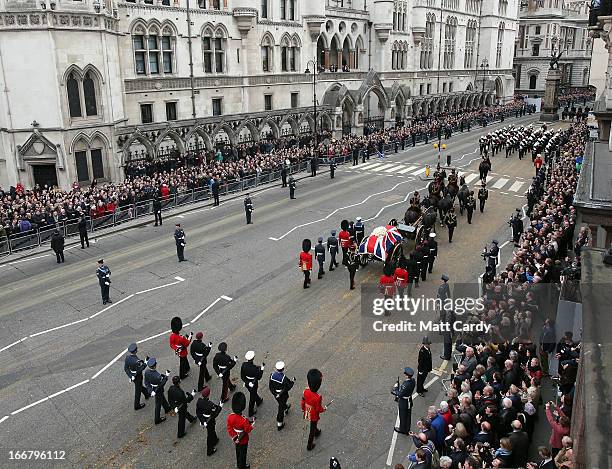 Crowds gather to watch as a Gun Carriage of The King's Troop Royal Horse Artillery carries the coffin of Former British Prime Minister Baroness...