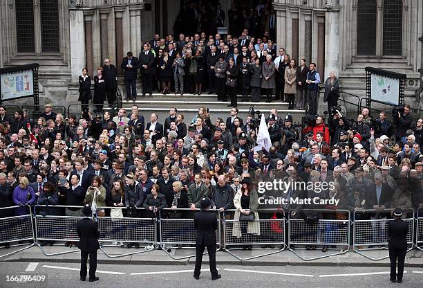 Crowds on the steps of the Royal Courts of Justice gather to watch as a Gun Carriage of The King's Troop Royal Horse Artillery carries the coffin of...