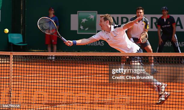 Jonathan Marray and Colin Fleming of Great Britain in action against Julian Knowle of Austria and Frederik Nielsen of Denmark in their first round...