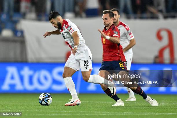 Georges Mikautadze of Georgia battles for possession with Fabian Ruiz of Spain during the UEFA EURO 2024 European qualifier match between Georgia and...