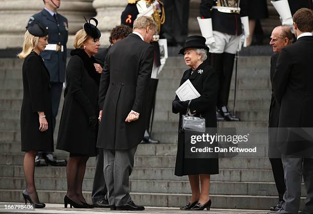 Queen Elizabeth II speaks with Mark Thatcher as she leaves St Paul's Cathedral after the Ceremonial funeral of former British Prime Minister Baroness...