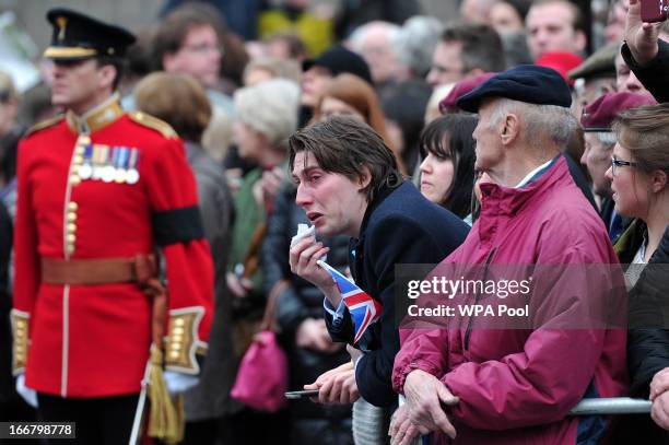 Member of public reacts as the coffin containing late British Prime Minister Baroness Margaret Thatcher is taken from St Clement Danes church during...