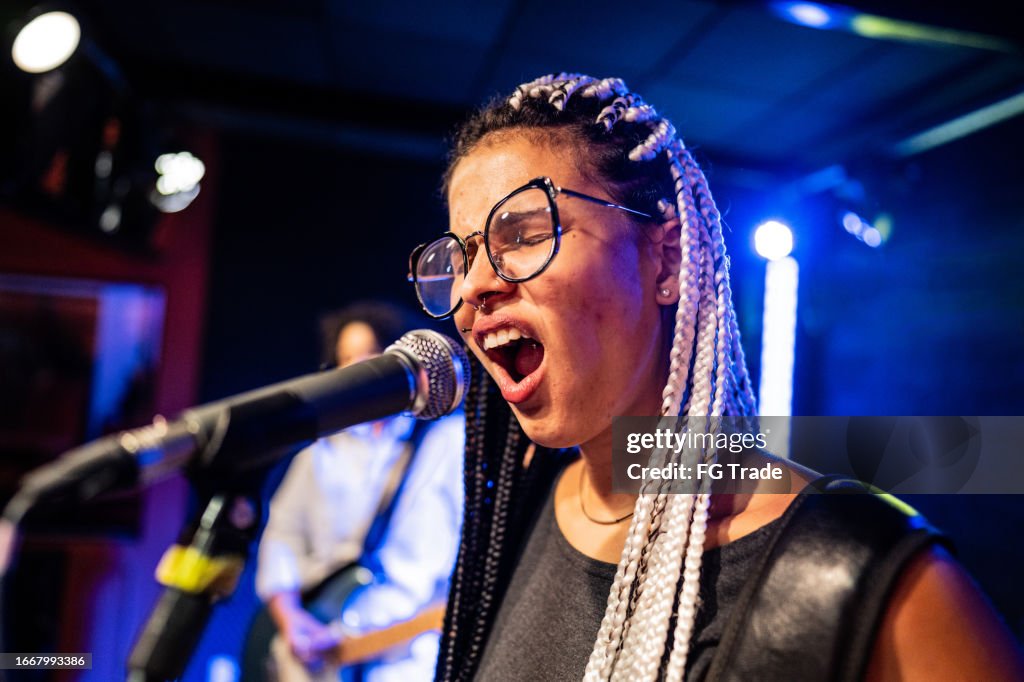 Young woman singing on a show