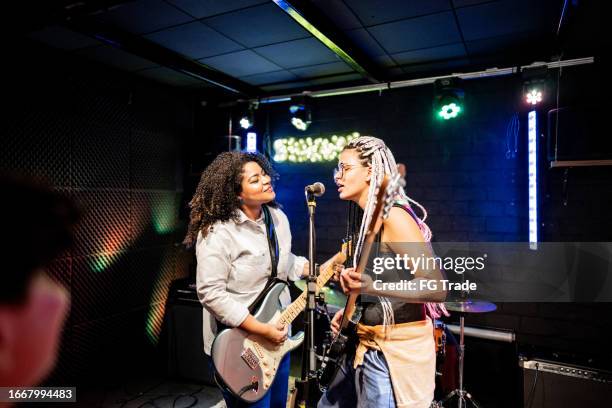musicians playing and singing on a show - rock group stock pictures, royalty-free photos & images