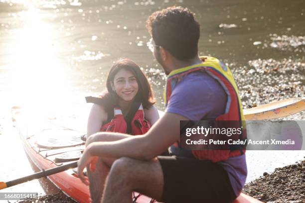 young couple prepare to go kayaking together - life jacket photos stock pictures, royalty-free photos & images