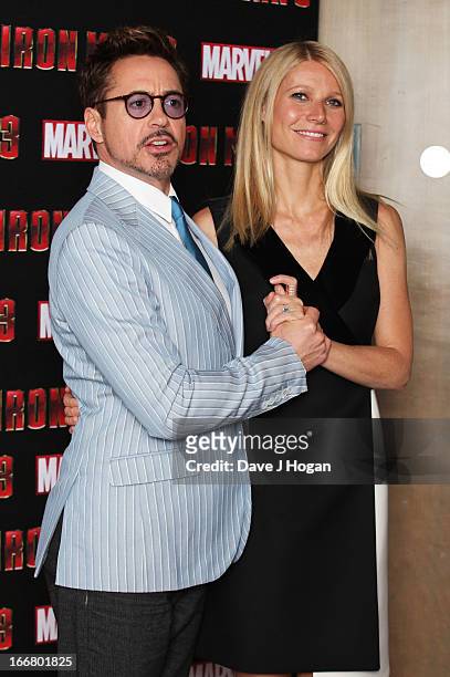 Gwyneth Paltrow and Robert Downey Jr attend a photocall for 'Iron Man 3' at The Dorchester Hotel on April 17, 2013 in London, England.