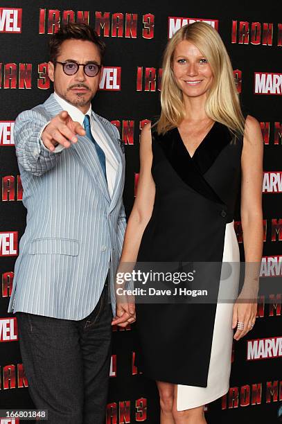 Gwyneth Paltrow and Robert Downey Jr attend a photocall for 'Iron Man 3' at The Dorchester Hotel on April 17, 2013 in London, England.