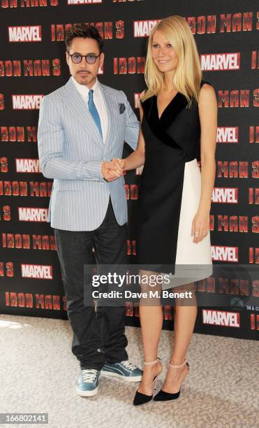 Robert Downey Jr and Gwyneth Paltrow pose at the Iron Man 3 photocall at The Dorchester on April 17, 2013 in London, England.