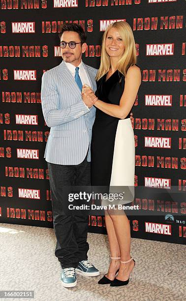 Robert Downey Jr and Gwyneth Paltrow pose at the Iron Man 3 photocall at The Dorchester on April 17, 2013 in London, England.