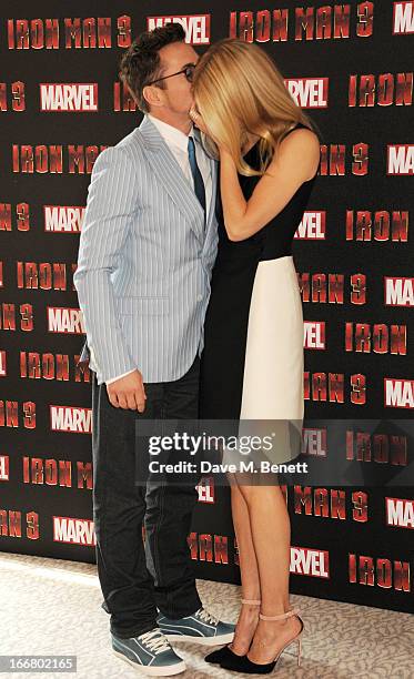 Robert Downey Jr and Gwyneth Paltrow pose at the Iron Man 3 photocall at The Dorchester on April 17, 2013 in London, England.