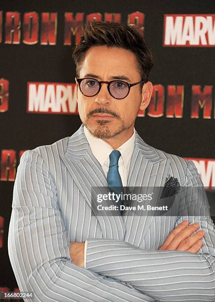 Robert Downey Jr poses at the Iron Man 3 photocall at The Dorchester on April 17, 2013 in London, England.