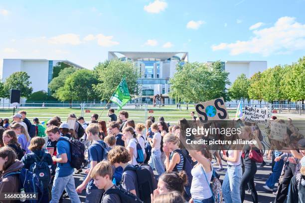 September 2023, Berlin: "SOS" is written on a poster as thousands of children, young people and adults take part in the protest action of the climate...