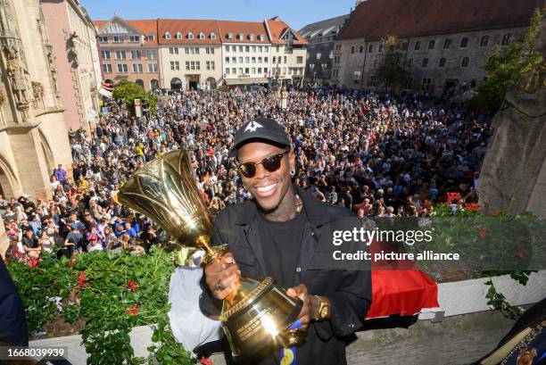 September 2023, Lower Saxony, Brunswick: Dennis Schröder, basketball world champion, stands on the balcony of Braunschweig's city hall during a...