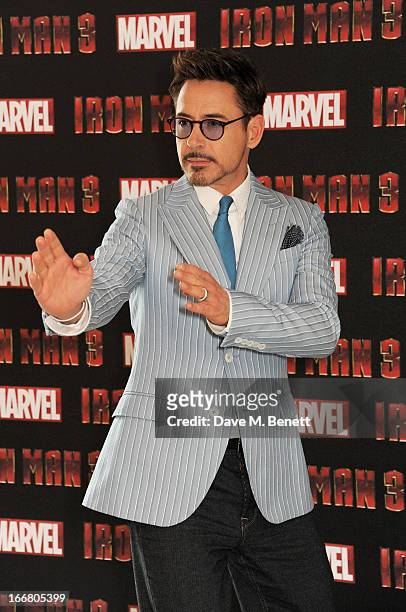 Robert Downey Jr poses at the Iron Man 3 photocall at The Dorchester on April 17, 2013 in London, England.