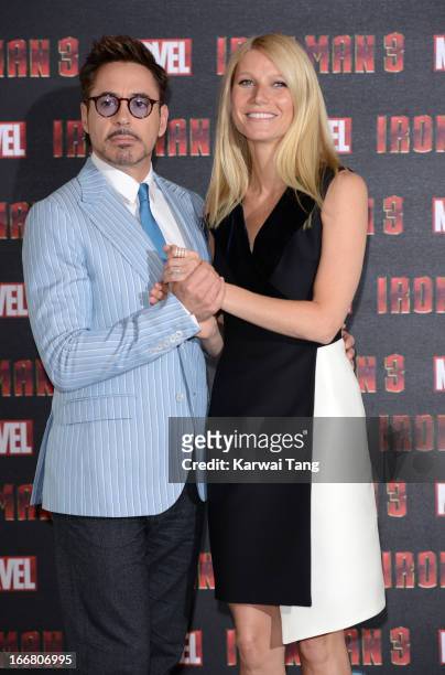 Robert Downey Jnr and Gwyneth Paltrow attend the Iron Man 3 photocall at The Dorchester on April 17, 2013 in London, England.