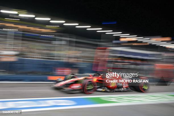 Ferrari's Spanish driver Carlos Sainz Jr leaves the pit lane during the second practice session ahead of the Singapore Formula One Grand Prix night...