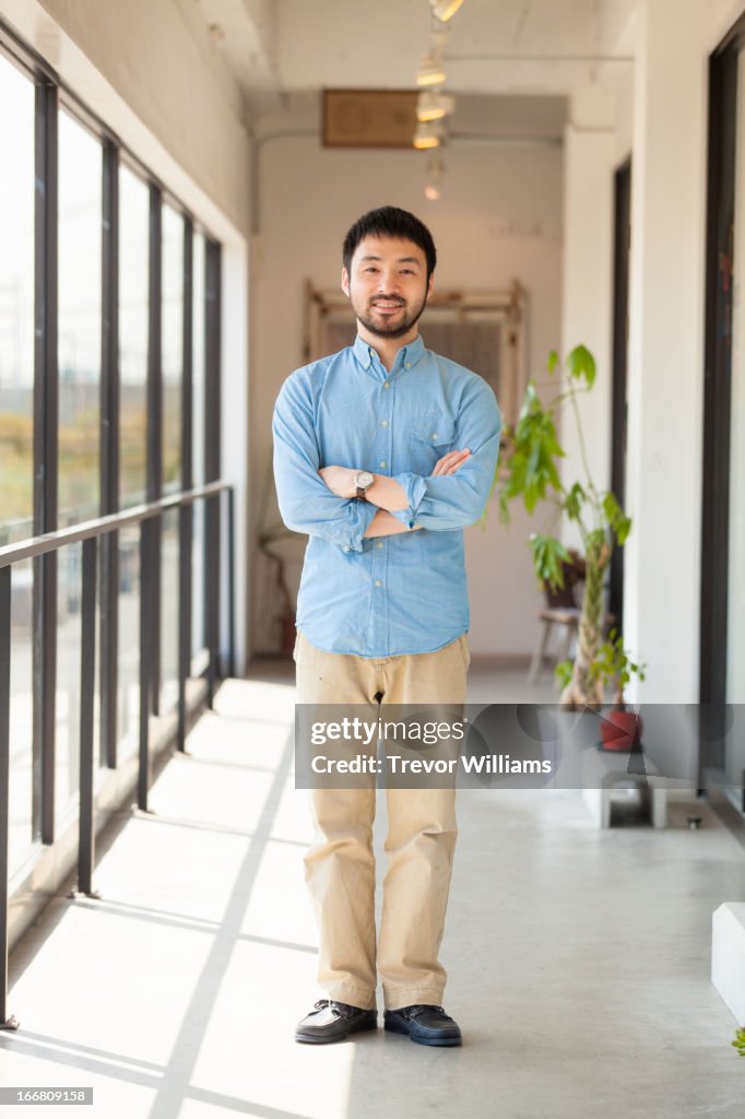 A man standing in bright corridor