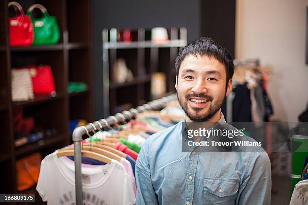 a male clerk standing in a boutique - retail occupation ストックフォトと画像