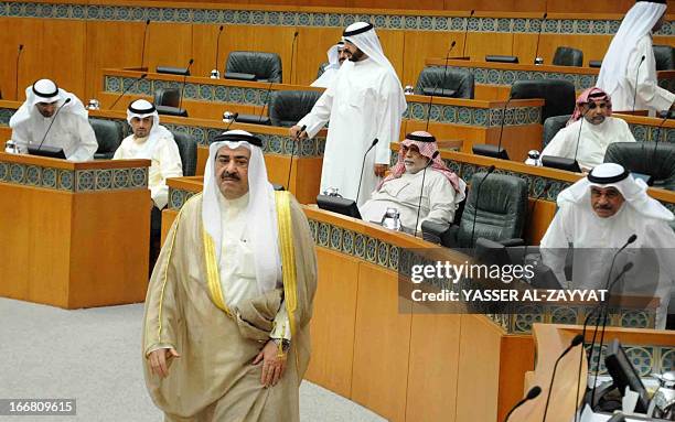 Kuwaiti Interior Minister Sheikh Ahmad al-Hmoud al-Sabah leaves the hall during a parliament session at Kuwait's national assembly in Kuwait City on...