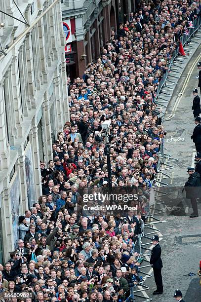 Crowds look on as the coffin of former British Prime Minister Margaret Thatcher arrives at St Paul's Cathedral on April 17, 2013 in London, England....