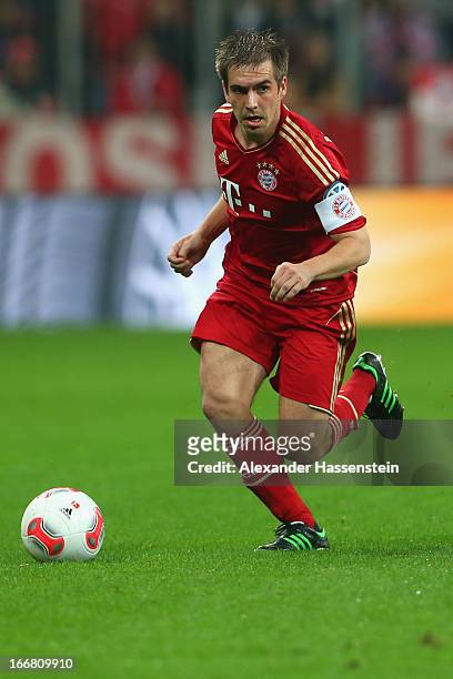 Philipp Lahm of Muenchen runs with the ball during the DFB Cup Semi Final match between Bayern Muenchen and VfL Wolfsburg at Allianz Arena on April...