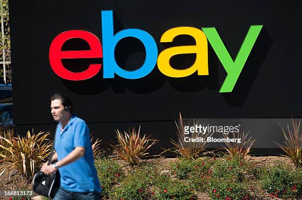 Pedestrian walks past eBay Inc. Signage outside of the company's headquarters in San Jose, California, U.S., on Tuesday, April 16, 2013. Ebay Inc. Is...