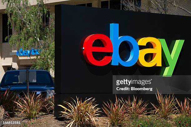 Car sits parked behind EBay Inc. Signage displayed at the company's headquarters in San Jose, California, U.S., on Tuesday, April 16, 2013. Ebay Inc....