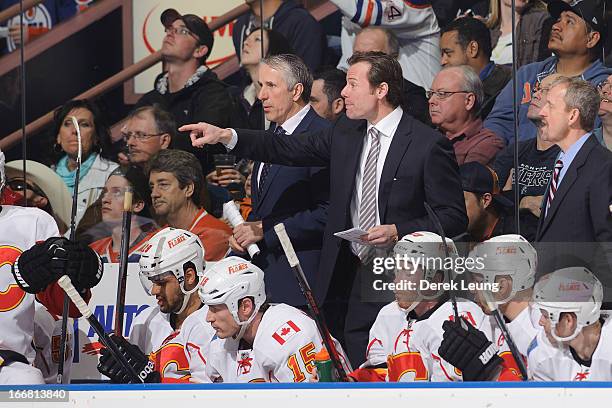 Bob Hartley , Martin Gelinas and Jacques Cloutier of the Calgary Flames talk to their players during a break in play against the Edmonton Oilers...