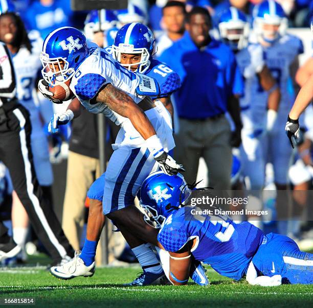 Receiver A.J. Legree is tackled by linebacker Kory Brown of the Kentucky Wildcats during the annual spring game at Commonwealth Stadium in Lexington,...