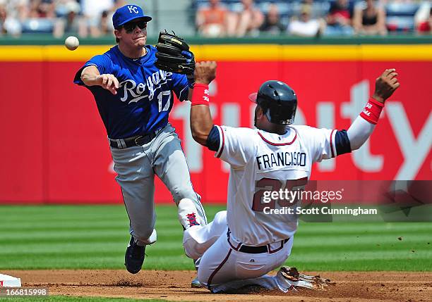 Chris Getz of the Kansas City Royals turns a double play against Juan Francisco of the Atlanta Braves at Turner Field on April 17, 2013 in Atlanta,...