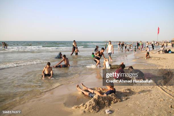 People visit the beach to get relief from high temperatures and long hours of power outages September 8, 2023 in Gaza City, Gaza.