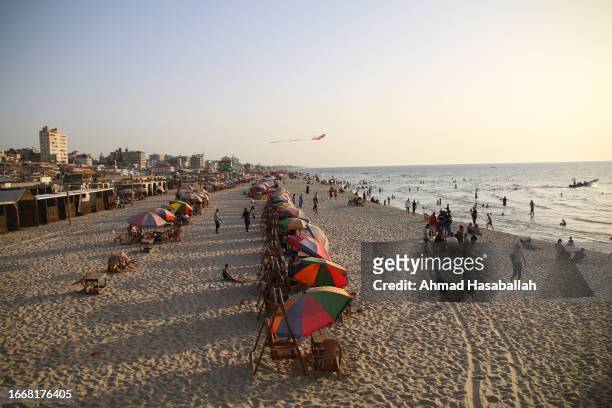 People visit the beach to get relief from high temperatures and long hours of power outages September 8, 2023 in Gaza City, Gaza.