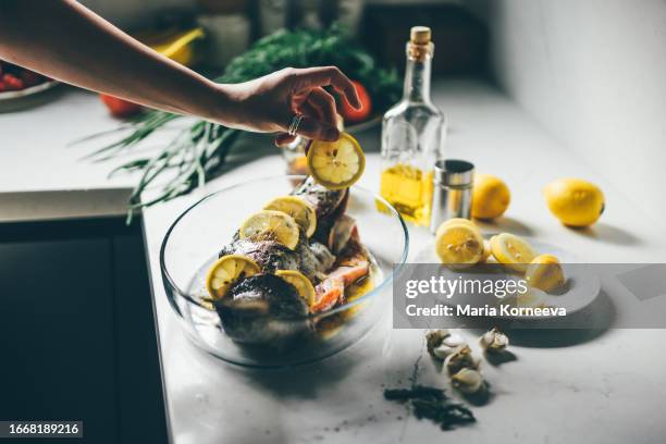 woman cooking fish at home. - marinated stock pictures, royalty-free photos & images