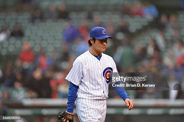Relief pitcher Hisanori Takahashi of the Chicago Cubs walks off the field against the San Francisco Giants at Wrigley Field on April 11, 2013 in...