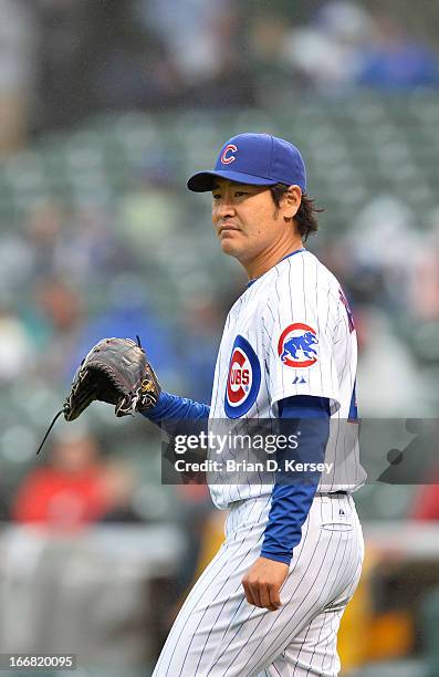 Relief pitcher Hisanori Takahashi of the Chicago Cubs stands on the field against the San Francisco Giants at Wrigley Field on April 11, 2013 in...