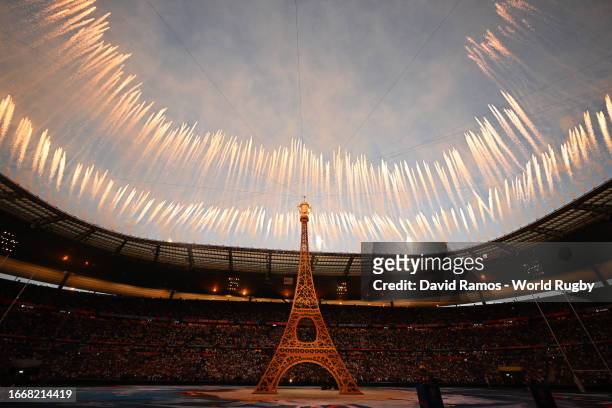 General view of the inside of the stadium, as a replica of the Eiffel Tower is seen, during the Opening Ceremony as flags of the competing nations...