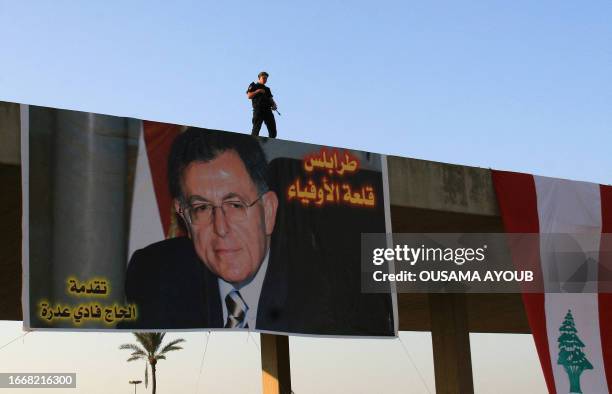 Member of the Lebanese special forces stands guard over a poster of Lebanese Prime Minister Fuad Siniora during a pro-government protest in the...