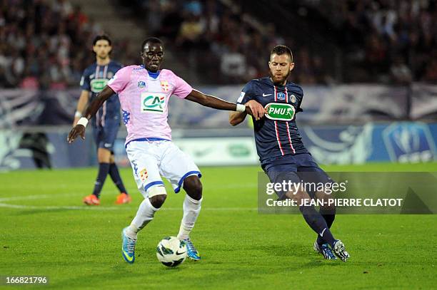 Evian's Ghanaian midfielder Mohammed Rabiu vies with Paris Saint-Germain's French midfielder Jeremy Menez during the French Cup quarter final...
