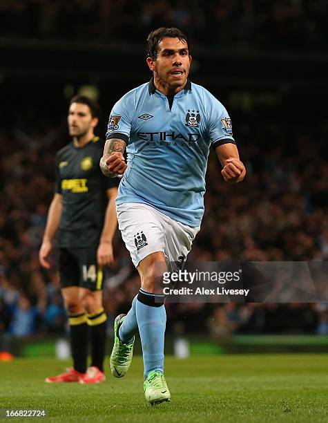 Carlos Tevez of Manchester City celebrates scoring the opening goal during the Barclays Premier League match between Manchester City and Wigan...
