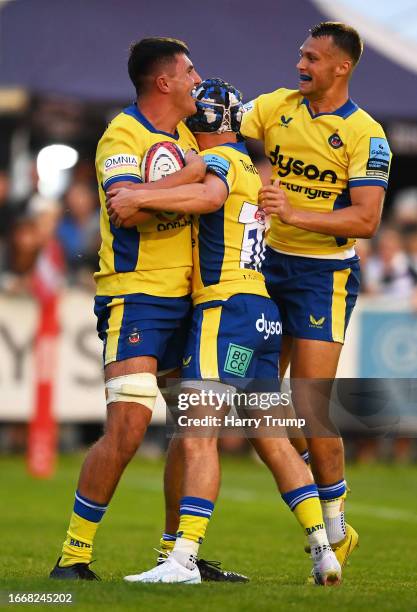 Ewan Richards of Bath Rugby celebrates their sides first try with team mates George Worboys and Tom Carr-Smith oduring the Premiership Rugby Cup...