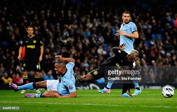 Vincent Kompany of Manchester City challenges Arouna Kone of Wigan Athletic during the Barclays Premier League match between Manchester City and...