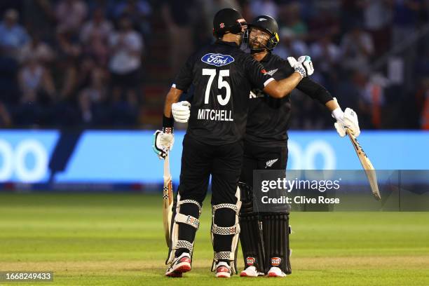 Devon Conway and Daryl Mitchell of New Zealand celebrate during the 1st Metro Bank One Day International between England and New Zealand at Sophia...