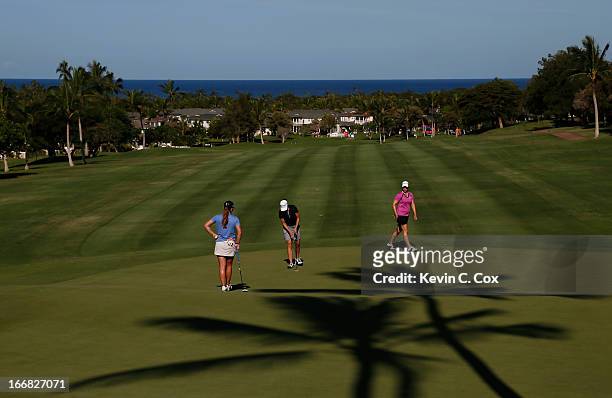 Austin Enst, Paige Mackenzie and Brittany Lincicome putt on the 14th green during the first round of the LPGA LOTTE Championship Presented by J Golf...